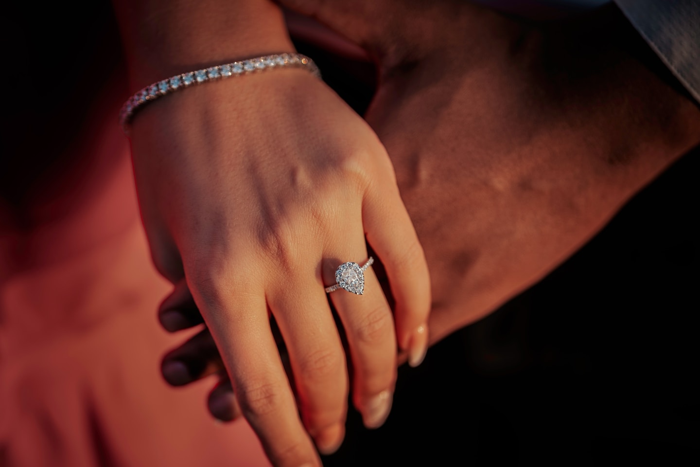 a close up of a person holding a diamond ring
