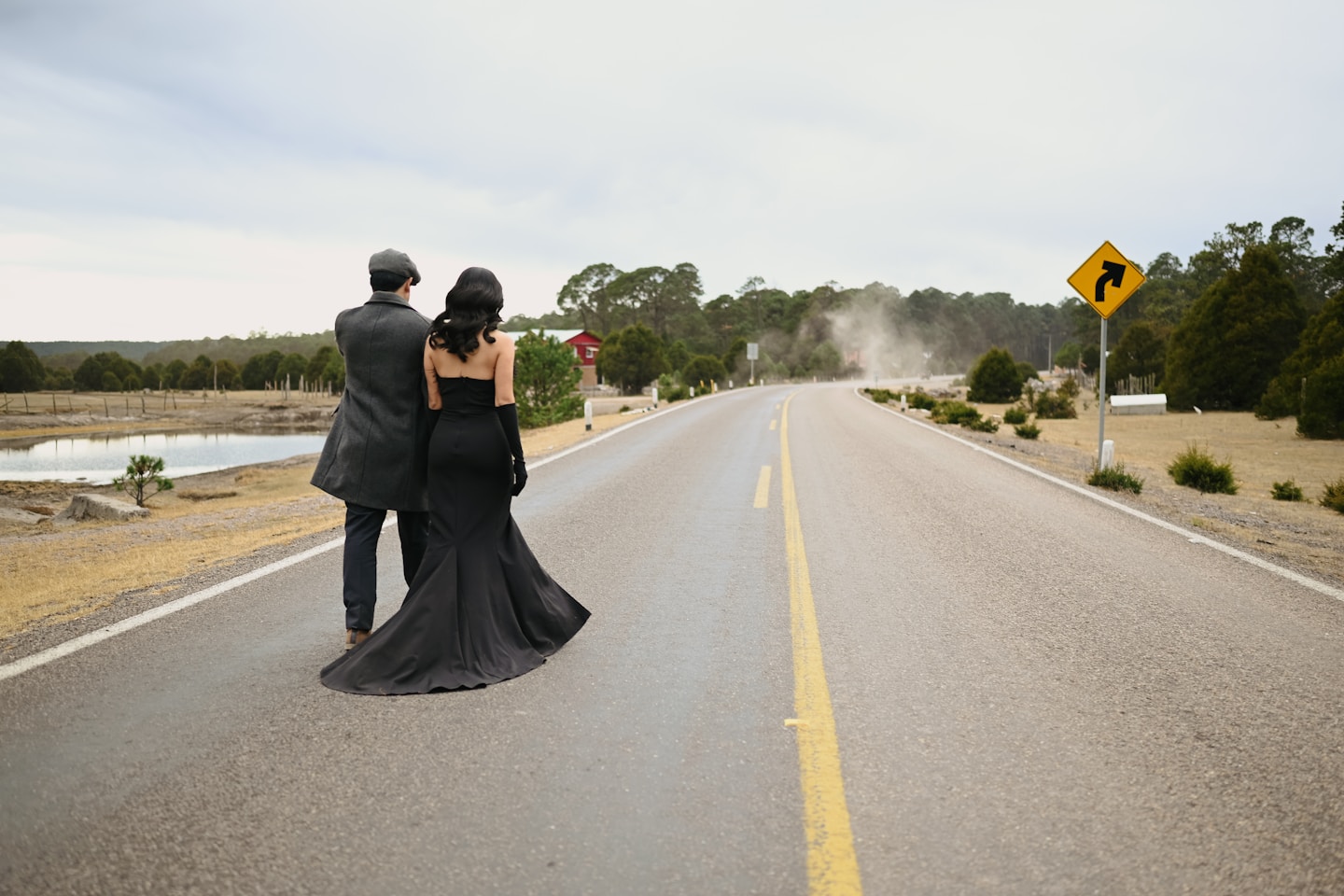 Couple walks down a desolate rural road